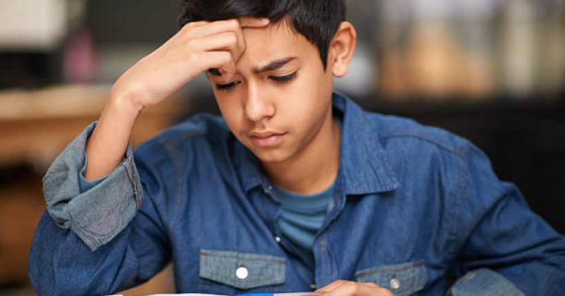 Shot of a young teenage boy studying at a desk